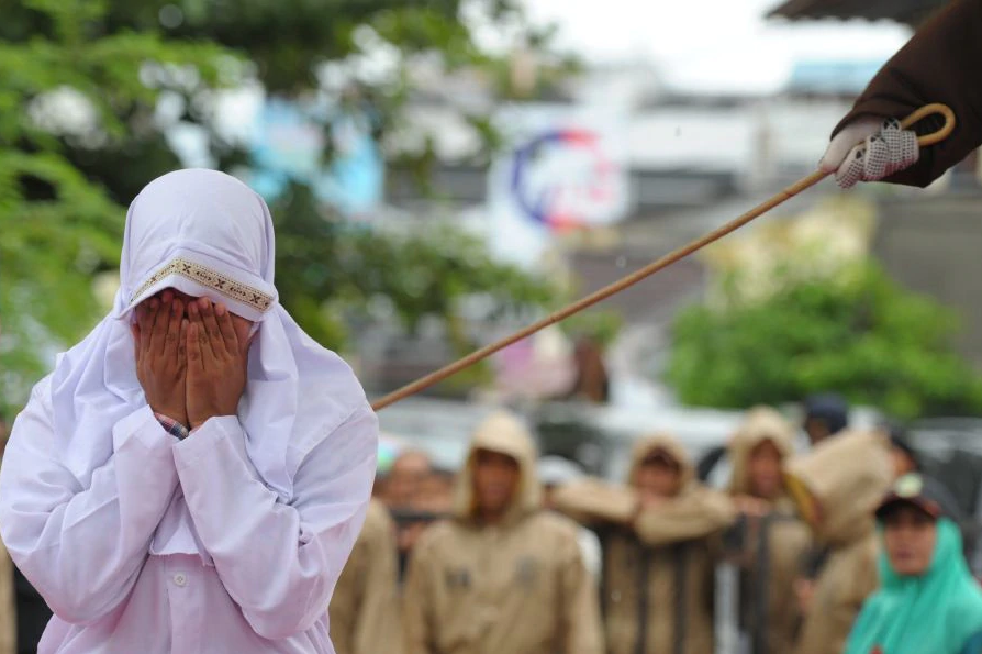 This picture depicts a Muslim women being caned in Acheh, Indonesia, where public caning has been implemented for nearly 20 years.